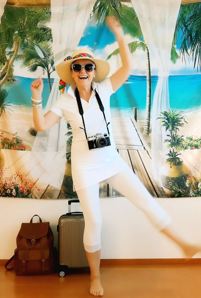 Woman lets loose, mood in full swing! Barefoot, in a white outfit and a smile she dances straight into the holiday.