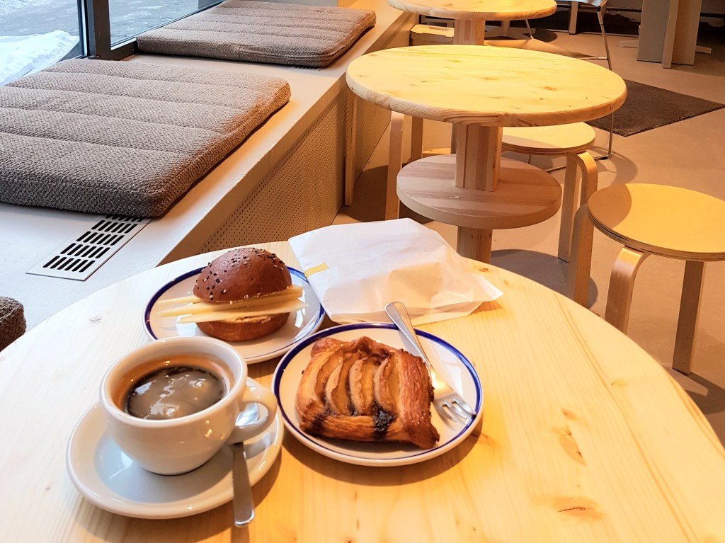 Interior of gluten free cafeteria with coffee, apple pastry and a cheese and ham sandwich on the table